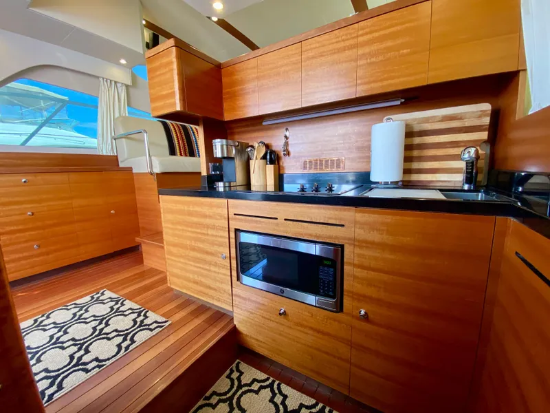 Slide: The Image of Luxurious 2014 Dyna 52 yacht kitchen with wood cabinetry and modern appliances. - 29