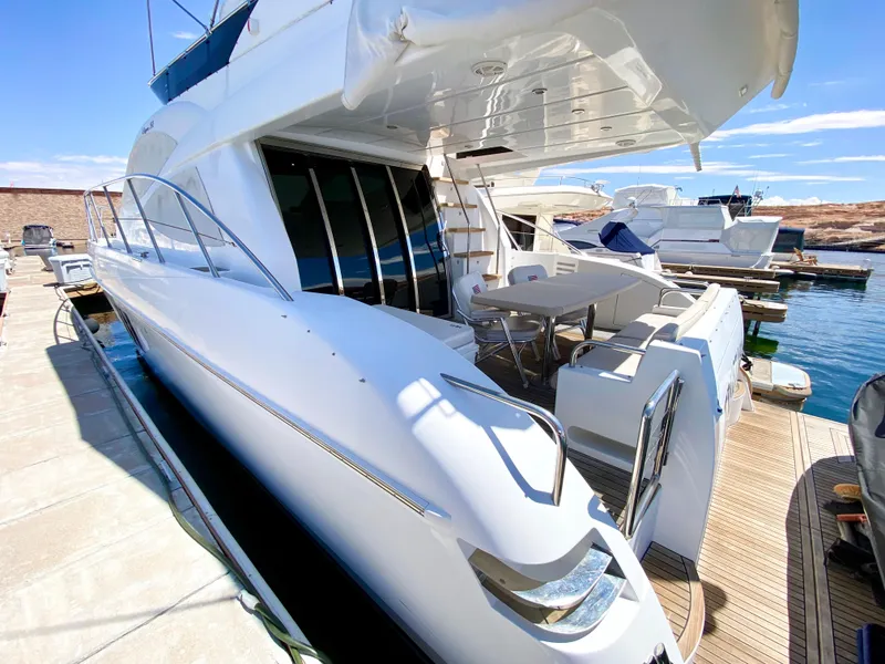 Slide: The Image of Luxurious 2014 Dyna 52 yacht docked at marina under clear blue sky. - 3