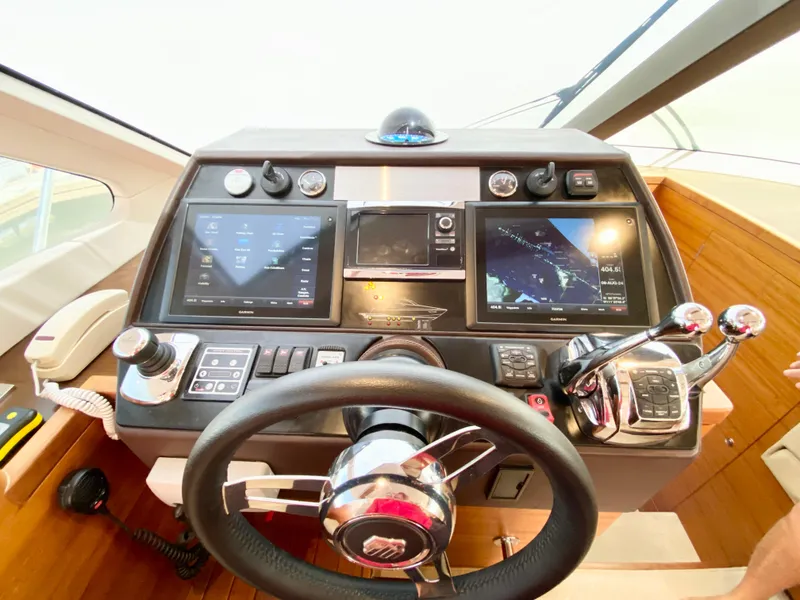 Slide: The Image of 2014 Dyna 52 yacht helm with advanced navigation controls and dual display screens. - 34