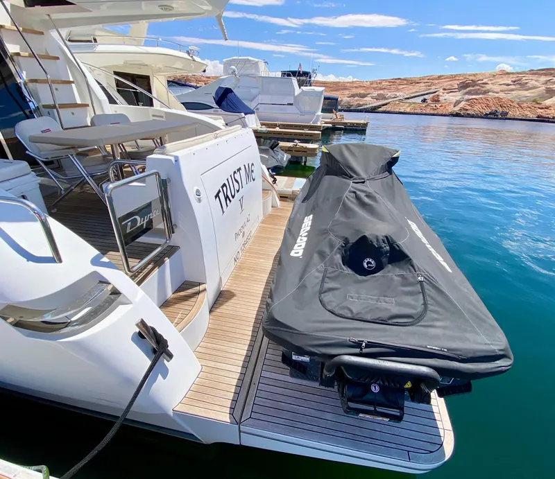Slide: The Image of 2014 Dyna 52 yacht docked with covered jet ski on platform. - 4