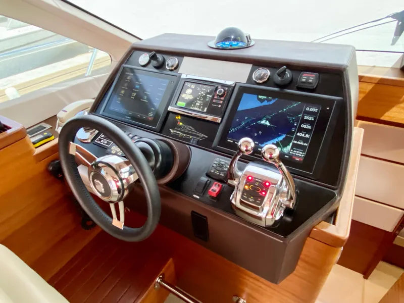 Slide: The Image of 2014 Dyna 52 yacht helm with advanced navigation controls and digital displays. - 41