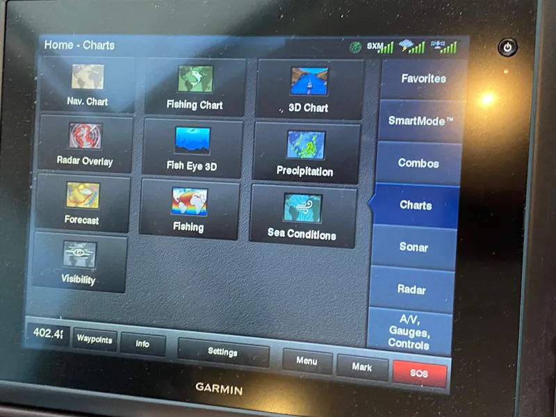 Slide: The Image of Garmin marine navigation display showing charts and settings on a Dyna 52, 2014 model. - 44
