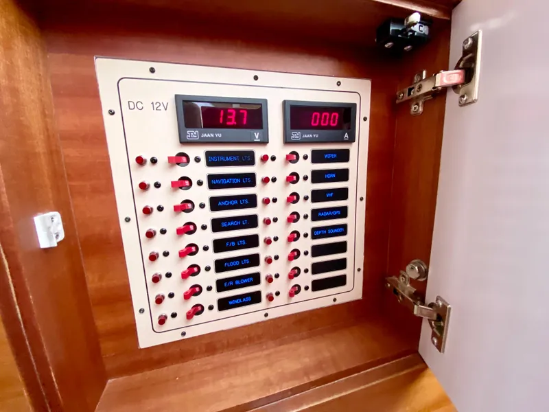 Slide: The Image of Electrical panel with switches and digital displays in a 2014 Dyna 52 boat. - 45