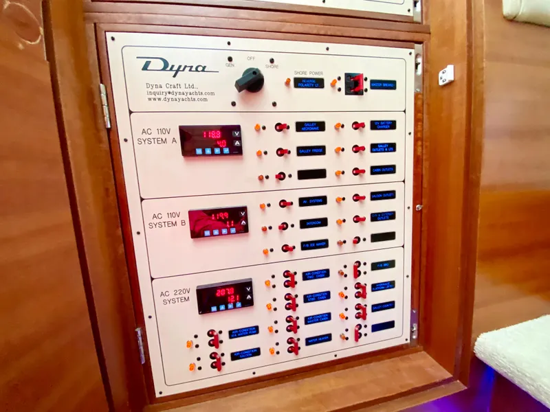 Slide: The Image of Dyna 52 yacht electrical panel, 2014 model, featuring AC systems and digital displays. - 46