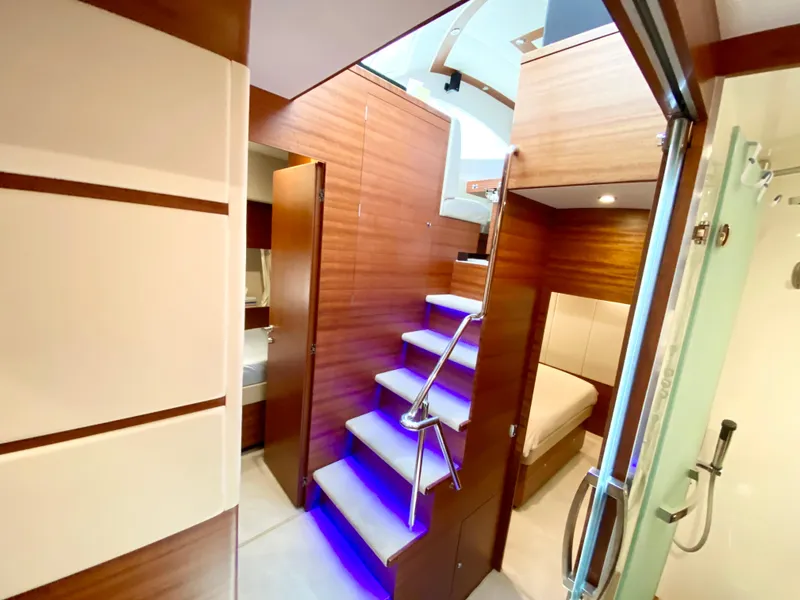 Slide: The Image of Luxurious interior of 2014 Dyna 52 yacht with modern wood paneling and illuminated stairs. - 48