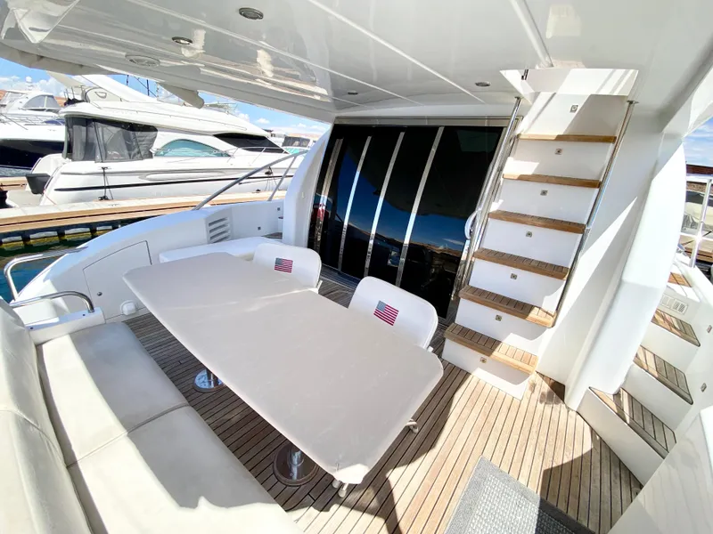 Slide: The Image of Luxurious 2014 Dyna 52 yacht deck with seating and table, docked at marina. - 7