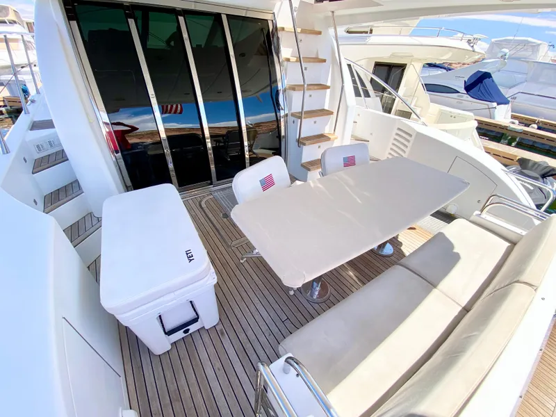 Slide: The Image of Spacious deck of 2014 Dyna 52 yacht with seating and table. - 8