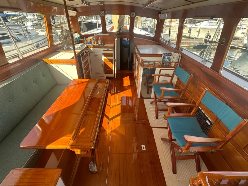 Slide: The Image of 1969 Calkins 50 Pilot House boat interior with wooden deck and American flag. - 14