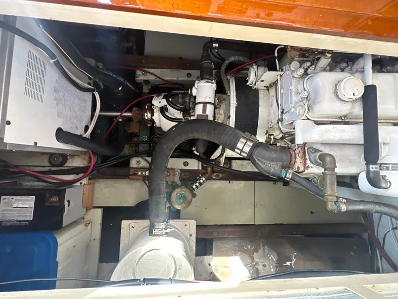 Slide: The Image of Engine compartment of a 1969 Calkins 50 Pilot House boat, showing mechanical components and wiring. - 15
