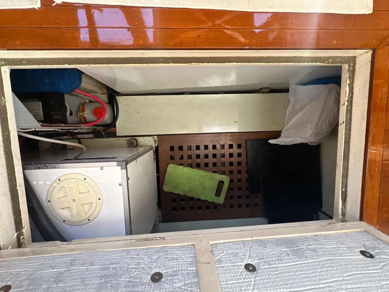 Slide: The Image of Engine compartment of a 1969 Calkins 50 Pilot House boat, showing equipment and storage. - 16