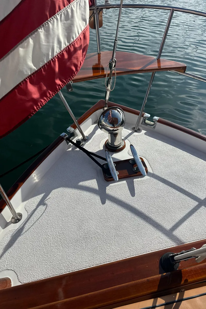 Slide: The Image of 1969 Calkins 50 Pilot House boat deck with flag and anchor detail. - 19