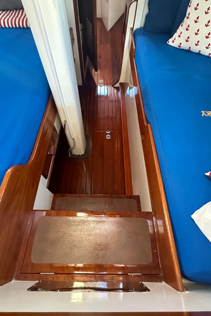 Slide: The Image of Interior of 1969 Calkins 50 Pilot House with wooden flooring and blue seating. - 23