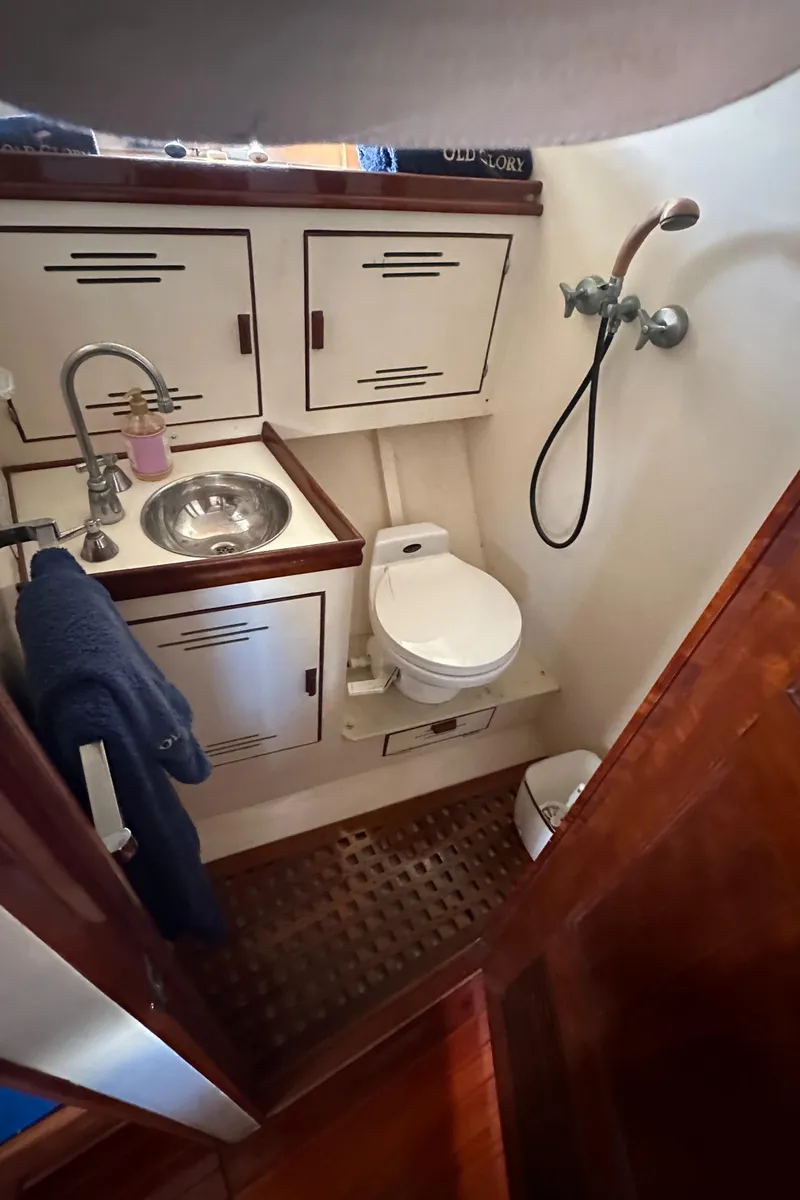 Slide: The Image of 1969 Calkins 50 Pilot House bathroom with sink, toilet, and shower. - 24