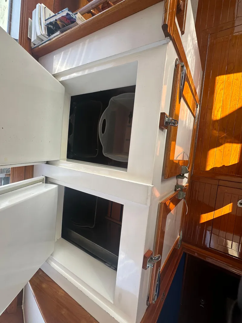 Slide: The Image of Open storage compartments on a 1969 Calkins 50 Pilot House boat interior. - 28