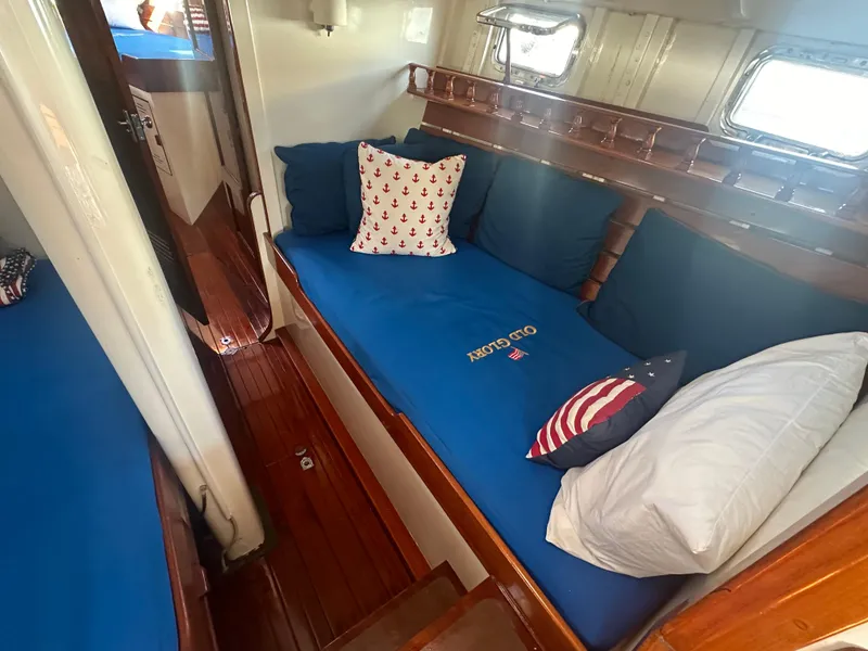 Slide: The Image of Interior of 1969 Calkins 50 Pilot House with blue cushions and nautical-themed pillows. - 29