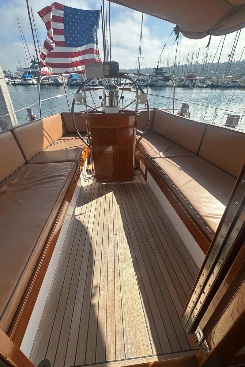 Slide: The Image of 1969 Calkins 50 Pilot House sailboat interior with American flag, docked at marina. - 30