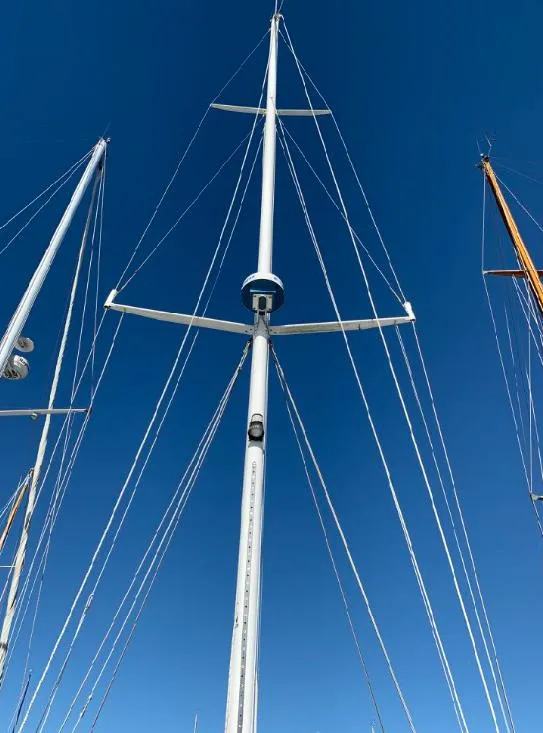Slide: The Image of Tall mast of a 1969 Calkins 50 Pilot House sailboat against a clear blue sky. - 33