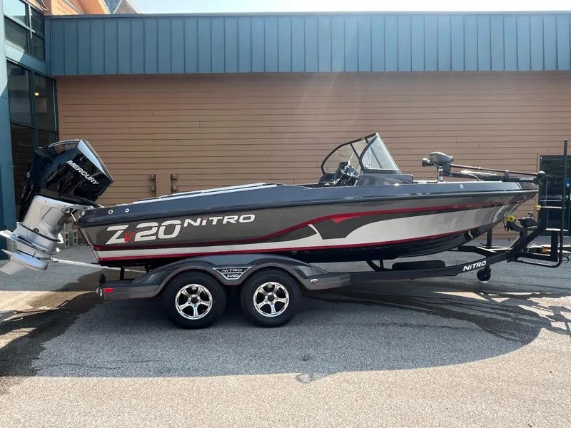 The Image of 2024 Nitro ZV20 Pro boat on trailer, sleek design, parked outdoors. - 0