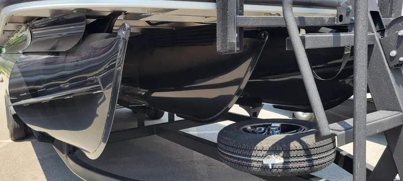 Slide: The Image of 2024 Ranger Reata 223FC pontoon boat underside with trailer and spare tire. - 2