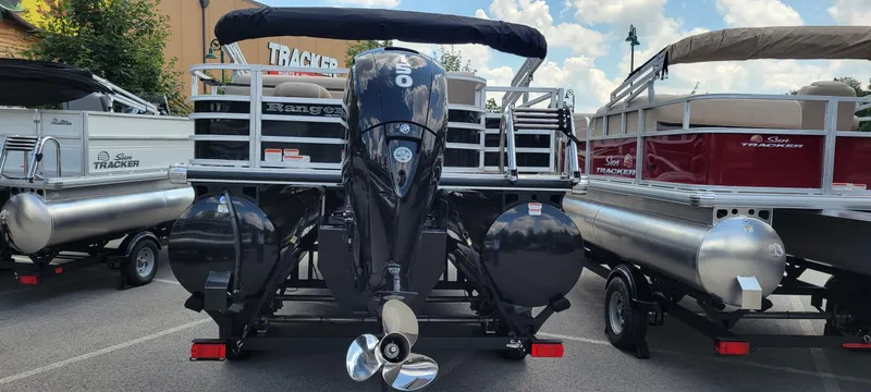 Slide: The Image of 2024 Ranger Reata 223FC pontoon boat with powerful outboard motor, displayed outdoors. - 3