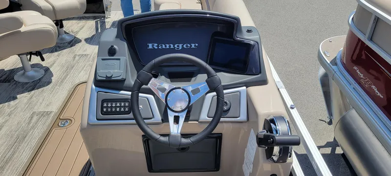 Slide: The Image of 2024 Ranger Reata 223FC boat dashboard with steering wheel and control panel. - 4