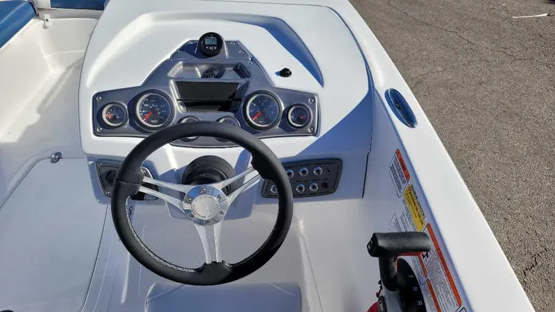 Slide: The Image of 2024 Tahoe 2150 boat dashboard with steering wheel and instrument panel. - 4