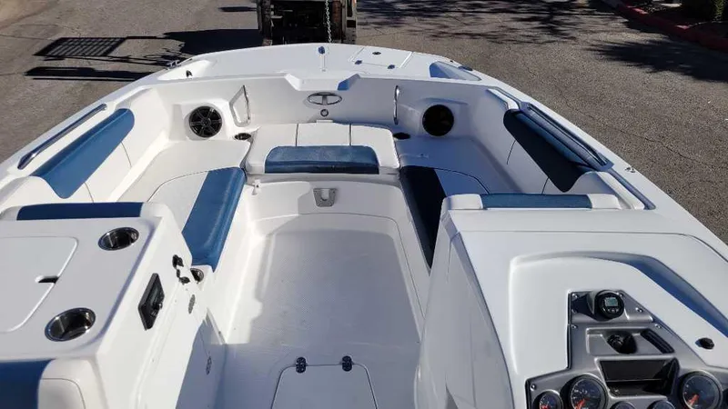 Slide: The Image of 2024 Tahoe 2150 boat interior with blue and white seating, cup holders, and dashboard controls. - 5