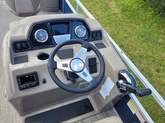 Slide: The Image of 2024 Ranger Reata 200F boat dashboard with steering wheel and controls. - 3