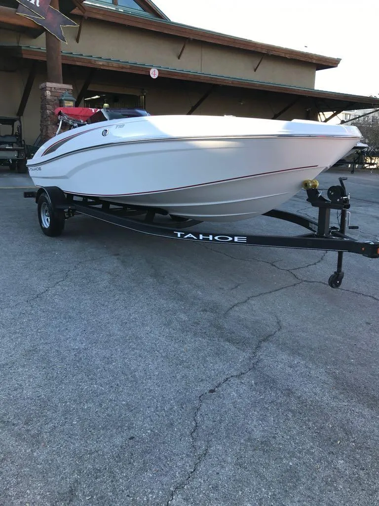 Slide: The Image of 2024 Tahoe T18 boat on trailer, parked outdoors. - 3