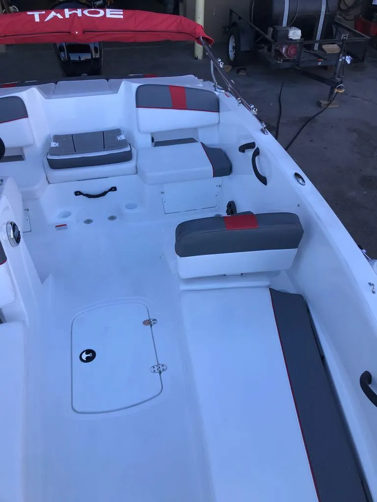 Slide: The Image of 2024 Tahoe T18 boat interior with red and gray seating, spacious layout. - 9