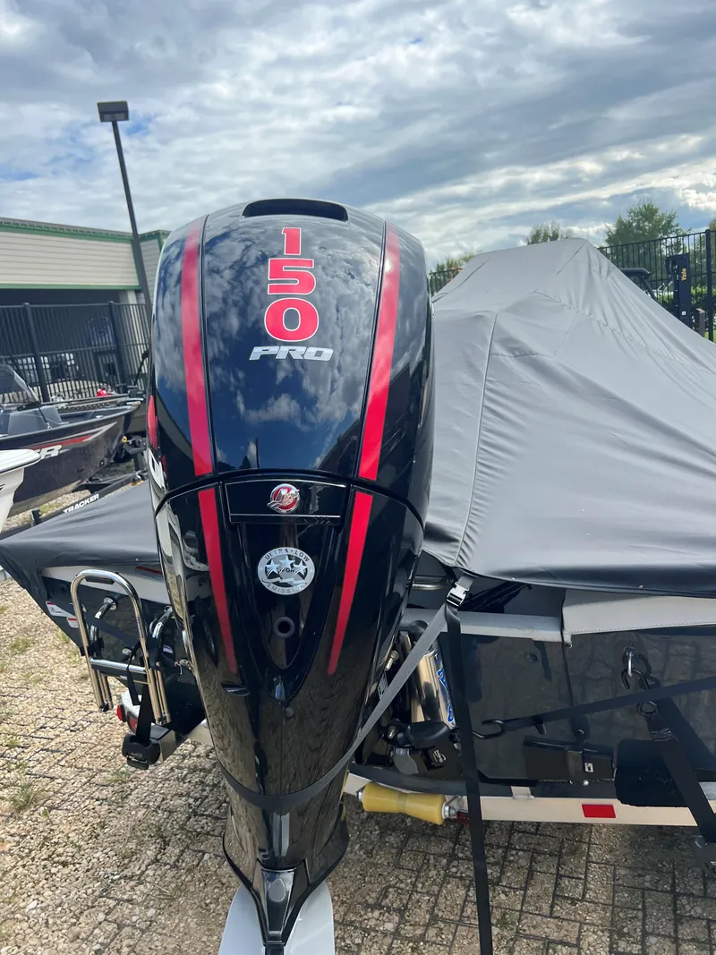 Slide: The Image of 2024 Ranger RB200 boat with 150 Pro engine, covered and parked outdoors. - 9