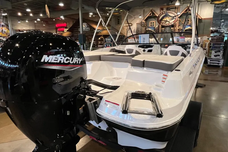 Slide: The Image of 2024 Tahoe 200 S boat with Mercury engine displayed indoors. - 3