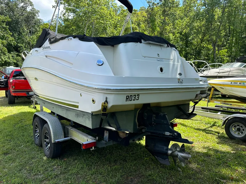 Slide: The Image of 2007 Sea Ray 240 Sundancer boat on trailer, parked on grass. - 2