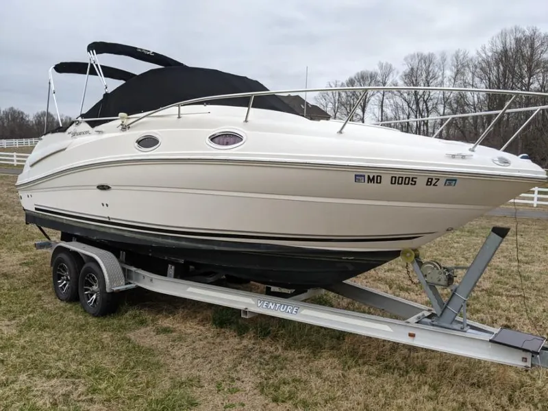 Slide: The Image of 2007 Sea Ray 240 Sundancer boat on trailer, parked on grass. - 4