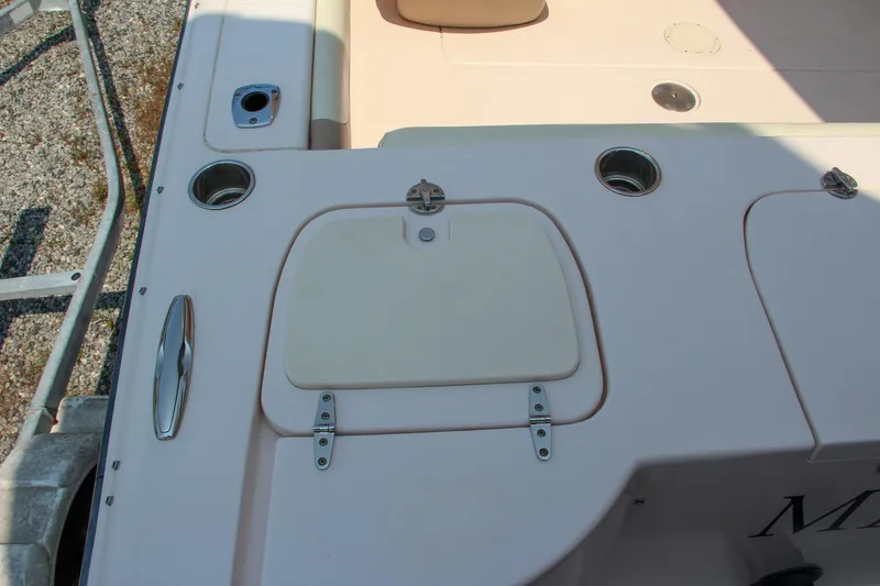 Slide: The Image of 2014 Grady-White Freedom 307 boat deck with storage compartment and cup holders. - 11