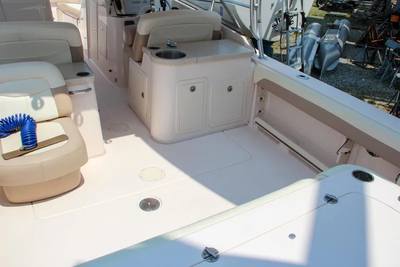 Slide: The Image of 2014 Grady-White Freedom 307 boat interior with seating and storage compartments. - 13
