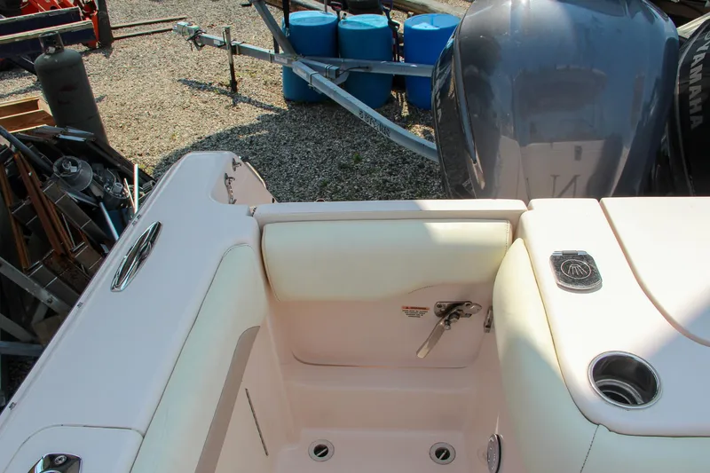 Slide: The Image of 2014 Grady-White Freedom 307 boat interior with engine and seating area. - 15