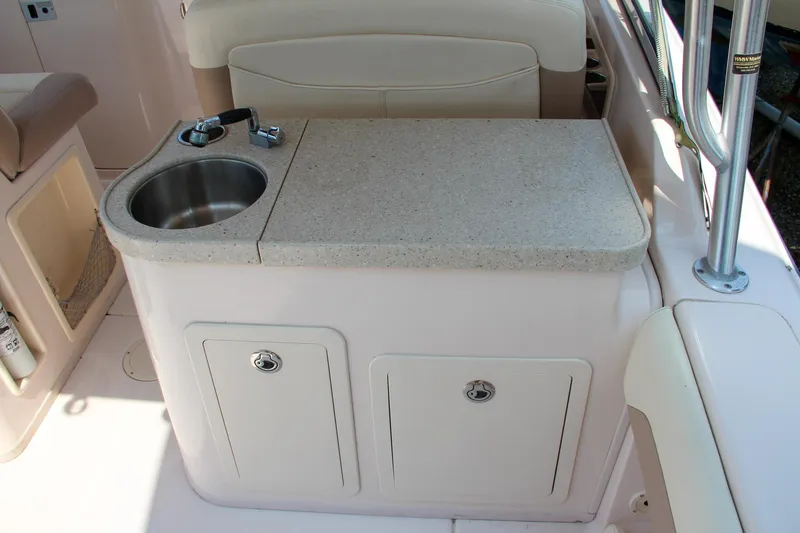 Slide: The Image of 2014 Grady-White Freedom 307 boat interior with sink and storage cabinets. - 16