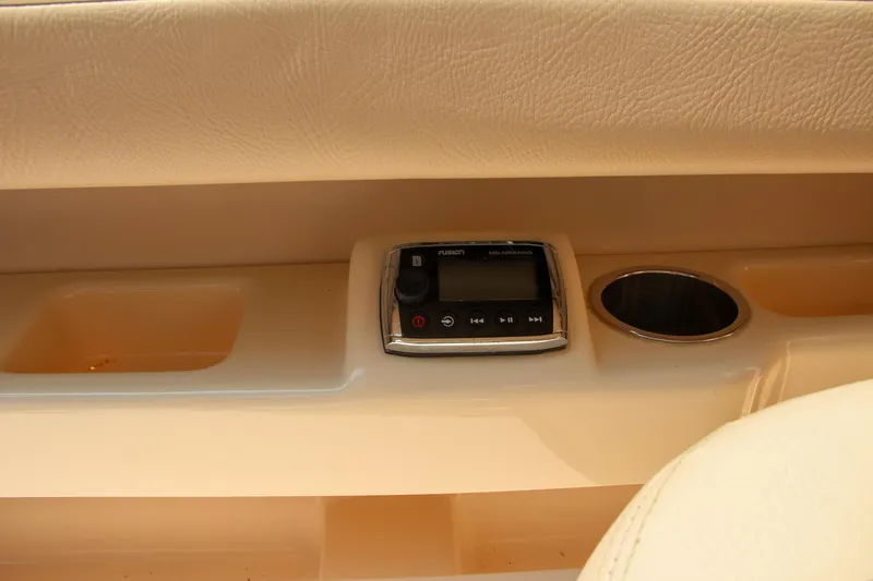 Slide: The Image of 2014 Grady-White Freedom 307 boat interior with control panel and cup holder. - 21