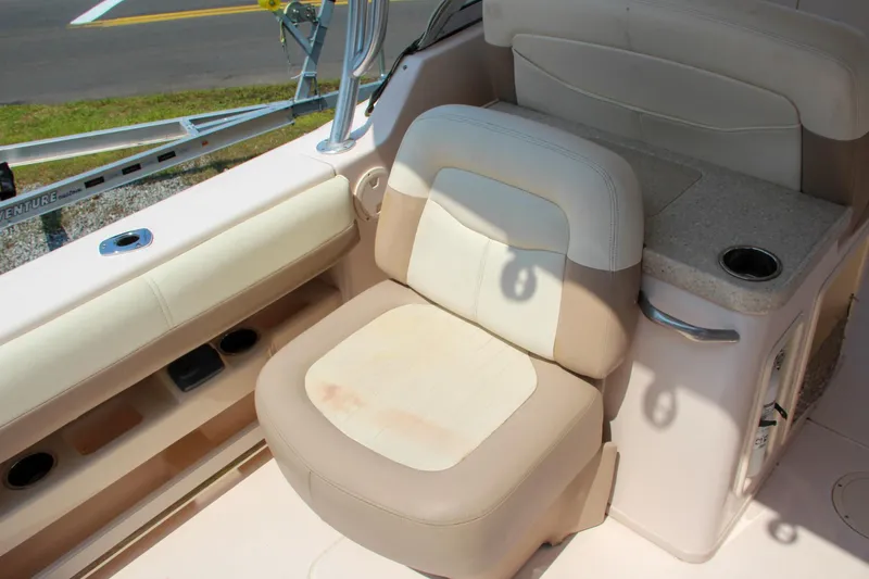 Slide: The Image of 2014 Grady-White Freedom 307 boat interior with beige seating and cup holder. - 22
