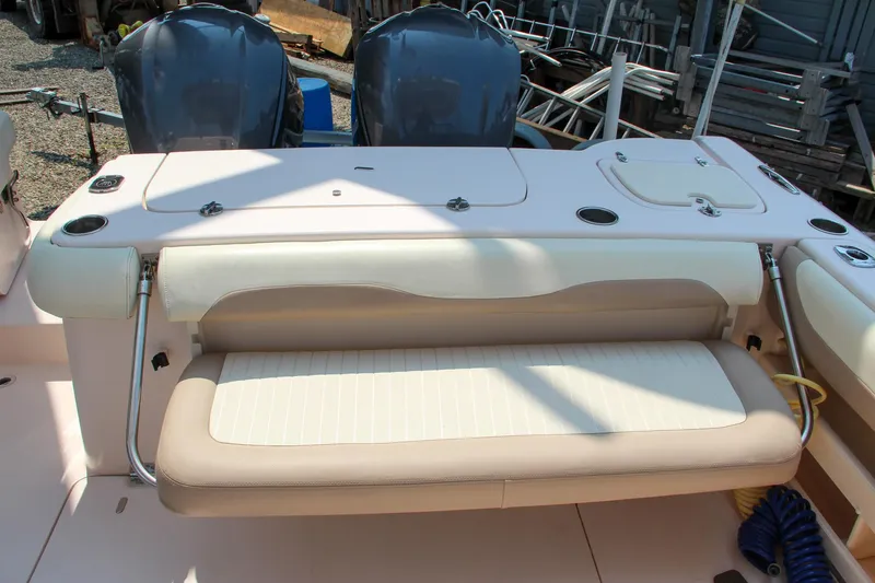 Slide: The Image of 2014 Grady-White Freedom 307 boat with dual engines and cushioned seating. - 24