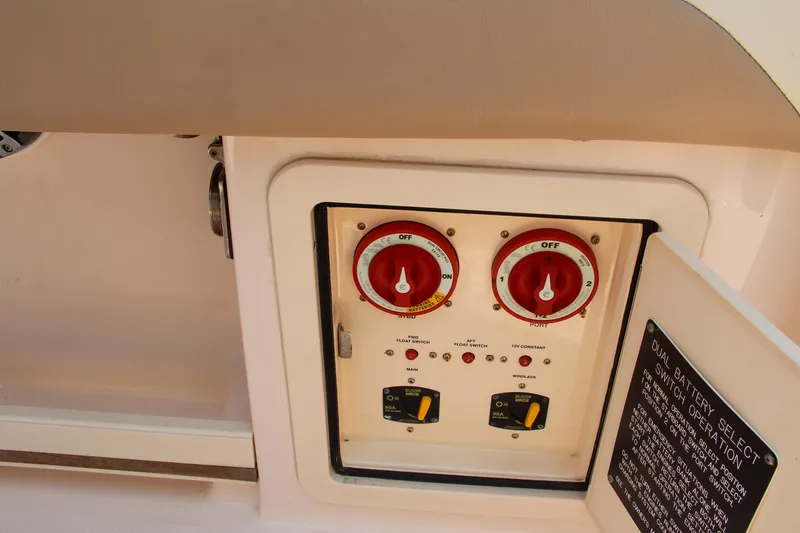 Slide: The Image of Control panel of a 2014 Grady-White Freedom 307 boat with switches and dials. - 25