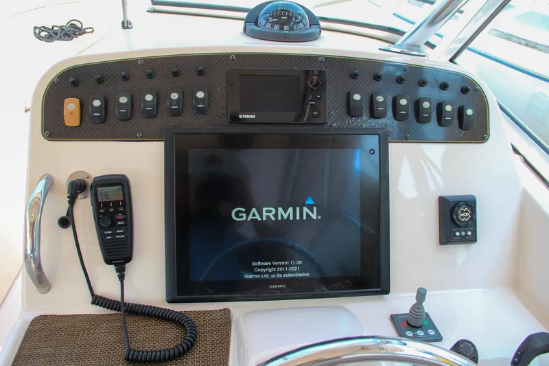 Slide: The Image of Grady-White Freedom 307 2014 boat dashboard with Garmin navigation system and controls. - 26