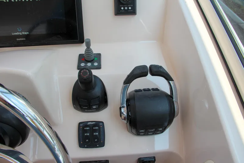 Slide: The Image of Control panel of 2014 Grady-White Freedom 307 boat with steering and throttle controls. - 27