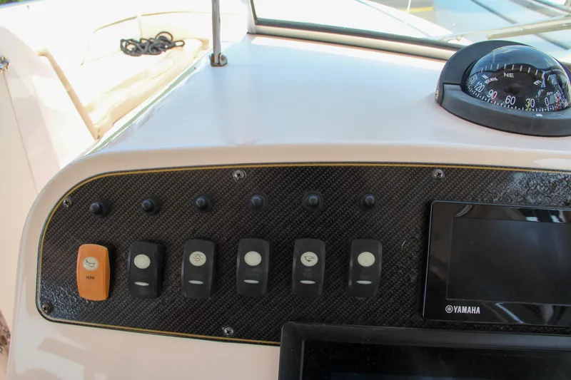Slide: The Image of Dashboard of 2014 Grady-White Freedom 307 boat with control switches and Yamaha display. - 29