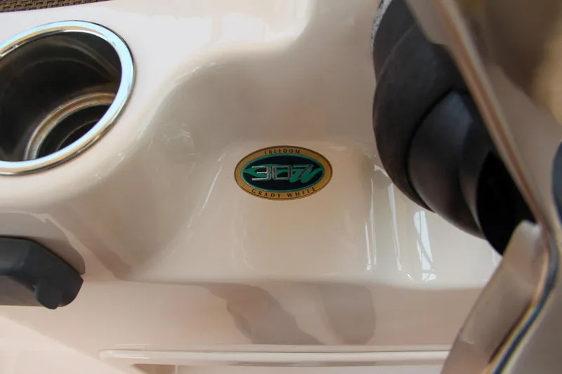 Slide: The Image of Close-up of 2014 Grady-White Freedom 307 boat emblem and cup holder. - 34