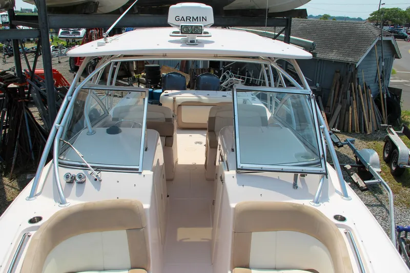 Slide: The Image of 2014 Grady-White Freedom 307 boat with Garmin equipment, docked outdoors. - 4