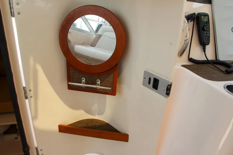 Slide: The Image of Interior of 2014 Grady-White Freedom 307 boat with mirror and radio. - 45