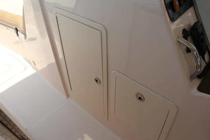 Slide: The Image of 2014 Grady-White Freedom 307 boat storage compartments and control panel. - 46