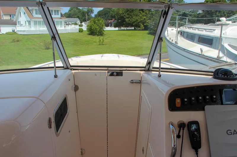 Slide: The Image of 2014 Grady-White Freedom 307 boat interior with control panel and windshield view. - 49